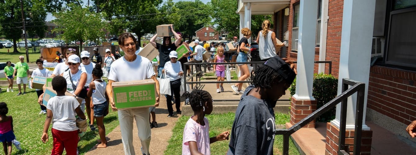 Volunteers handing boxes to recipients