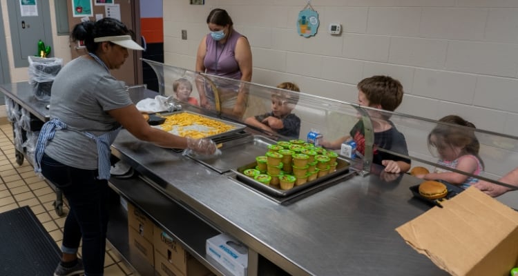 Children getting food in a cafeteria line