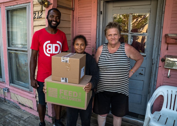 Dezmond with boxes on a porch