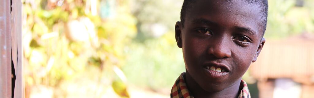 A boy standing outdoors in Kenya