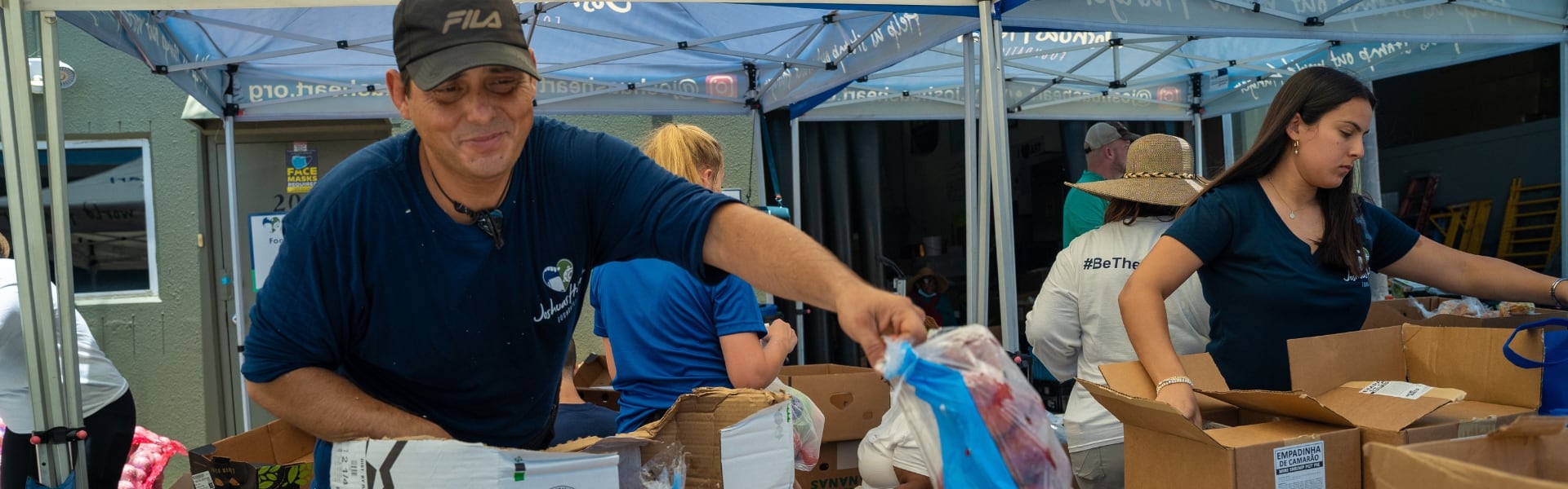 A group of volunteers filling boxes with supplies