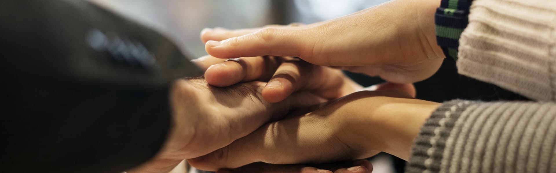 A group of hands stacked on top of each other