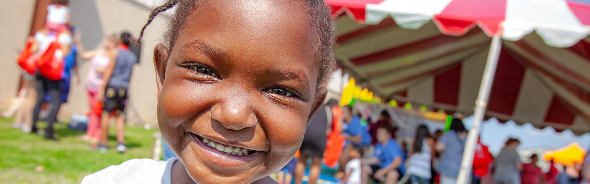 A girl smiling at an outdoor box event