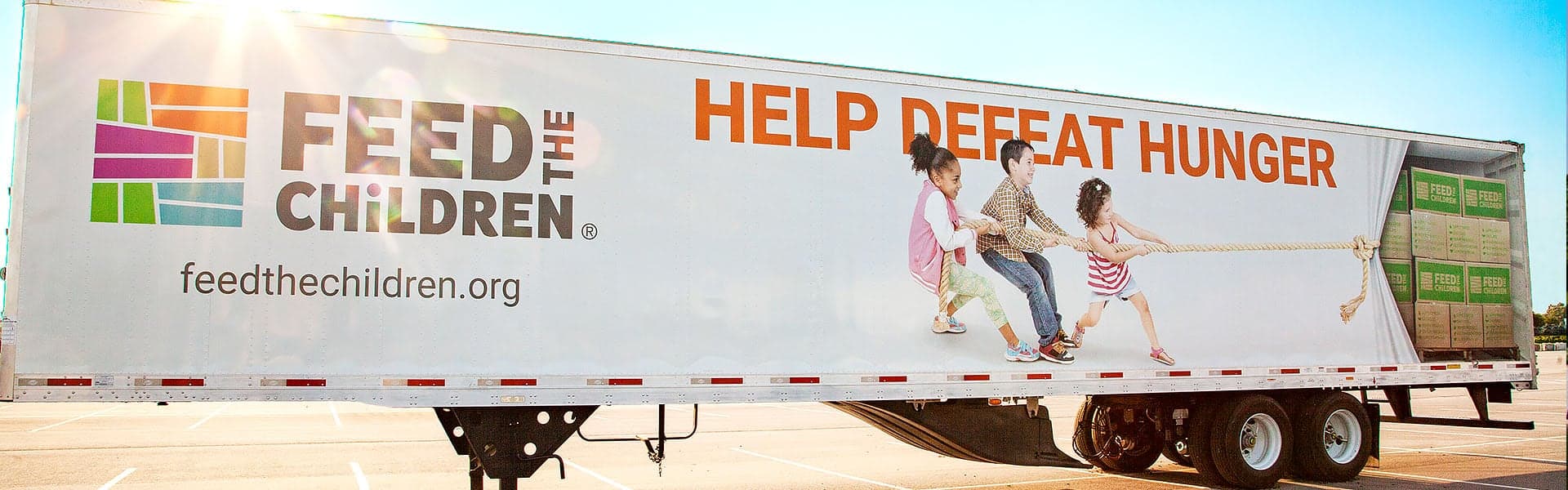 A Feed the Children semi trailer outdoors at an event