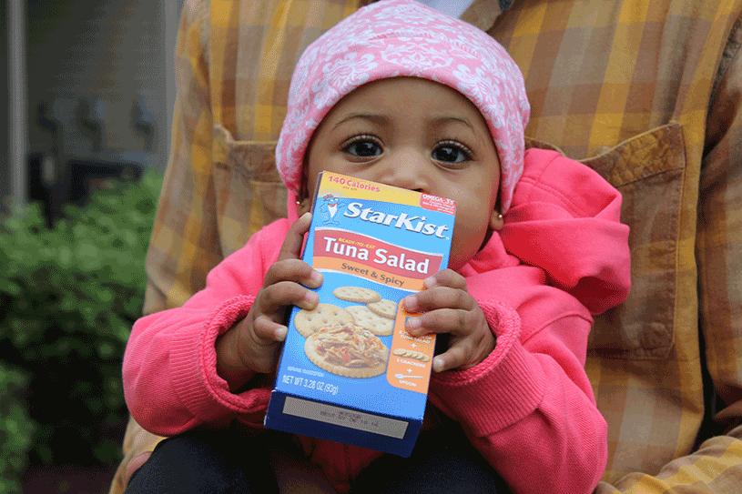 A child with a StarKist tuna box