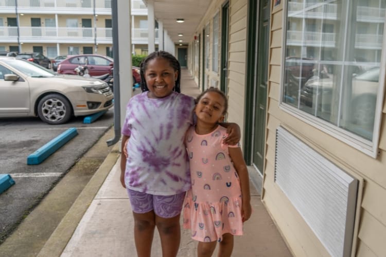 Two children hugging outdoors