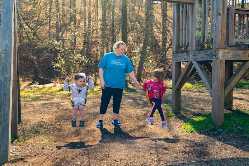 mom with children on swings