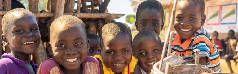 Children smiling outdoors in Africa