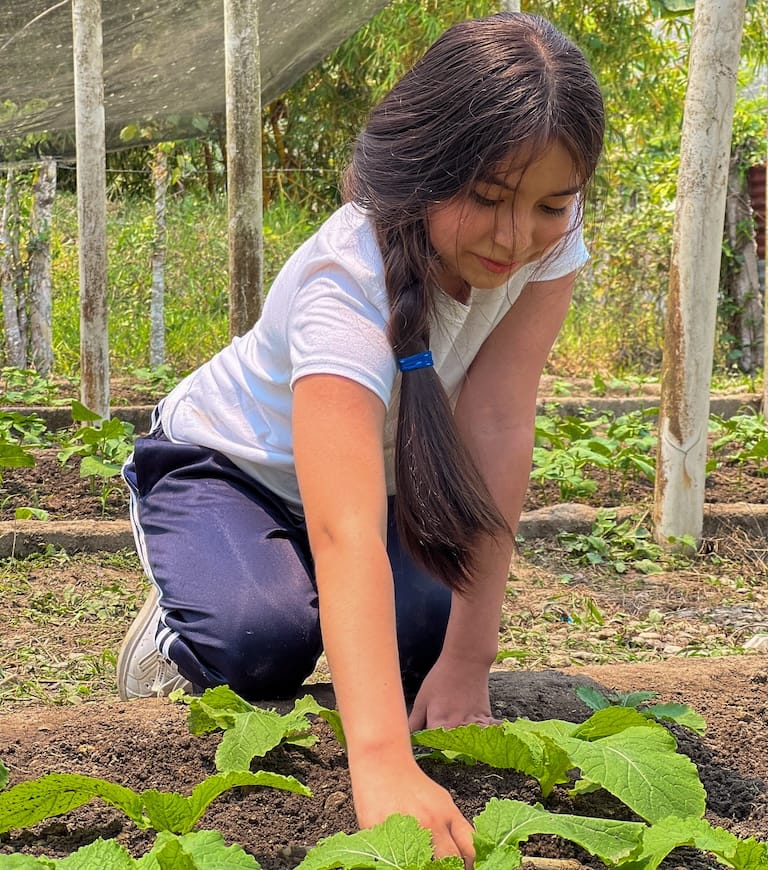 A girl gardening outdoors in south america