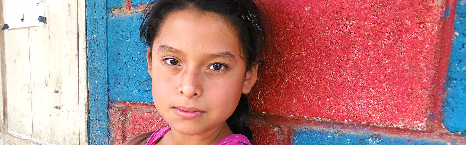 A child next to a wall in Guatemala