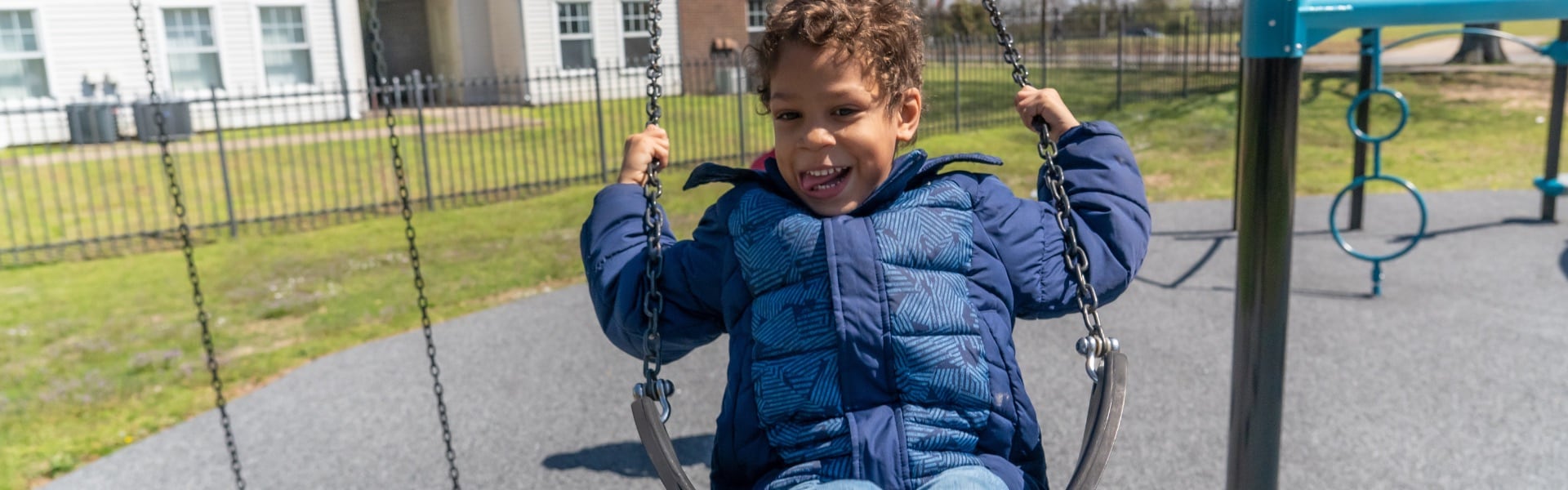 A boy swinging on a playground