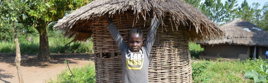 A boy holding his hands up outdoors