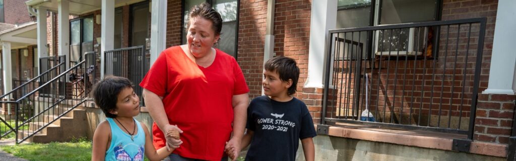 A woman and her two children walking outdoors