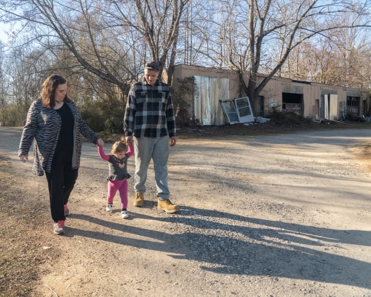 Lana and Dwayne walking with Finley
    