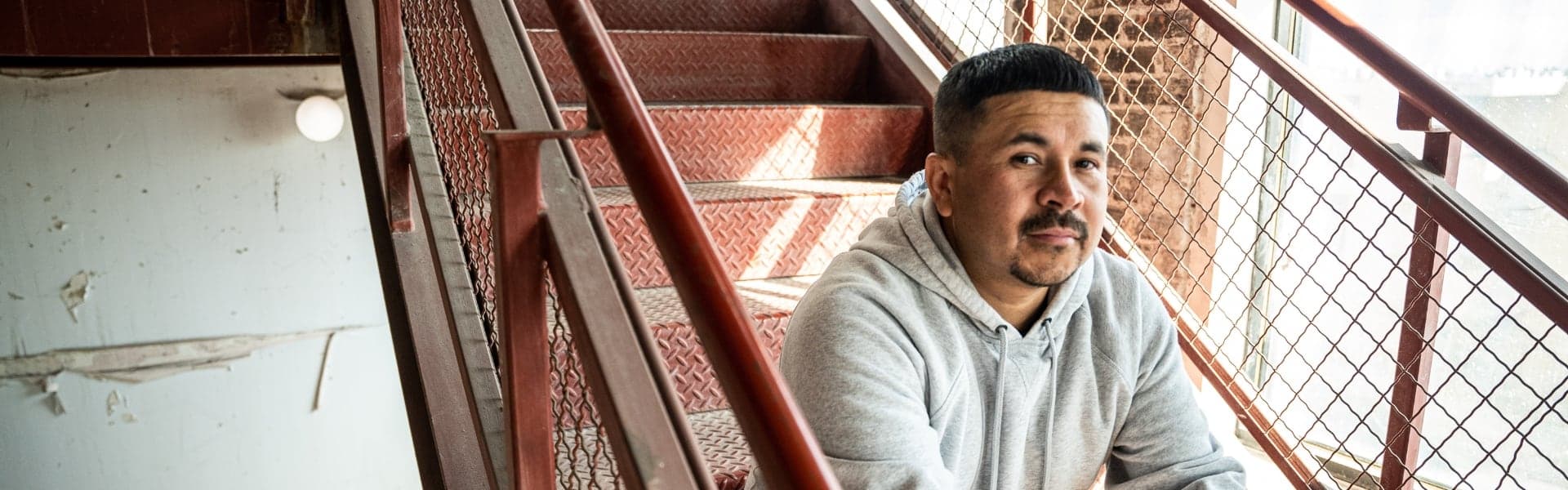 A man sitting on stairs outdoors