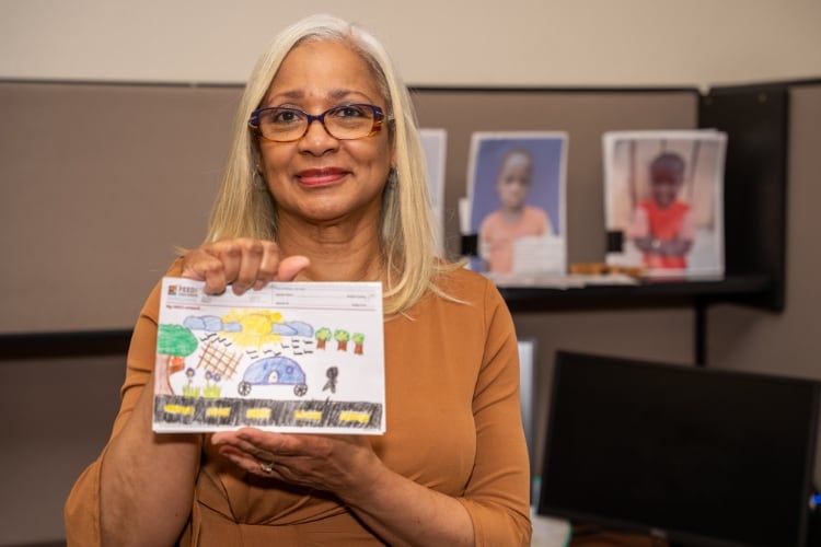 Deb Riley holding a drawing in her hands