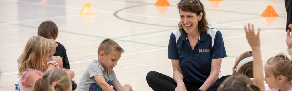 Tamara and children in a gym at an event