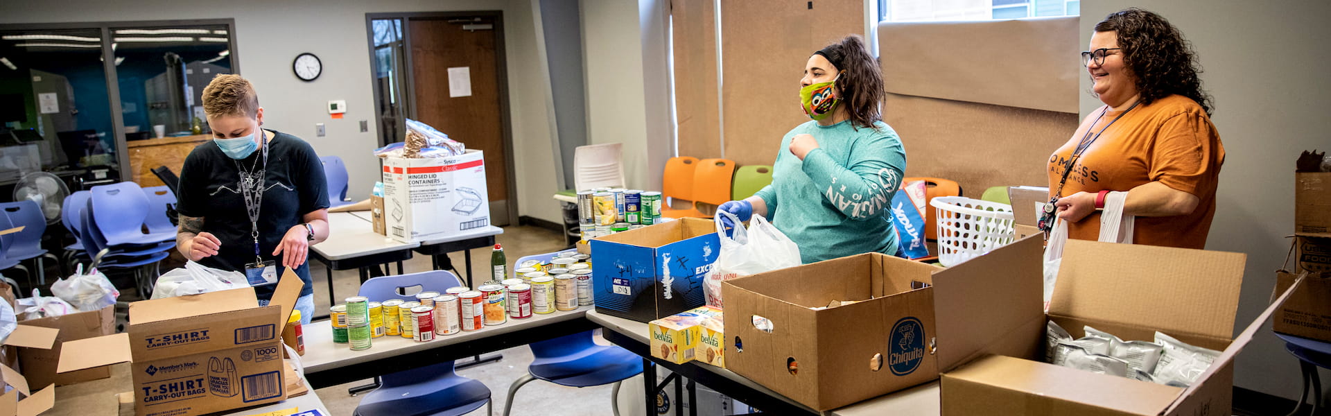 A group of people filling boxes with food supplies