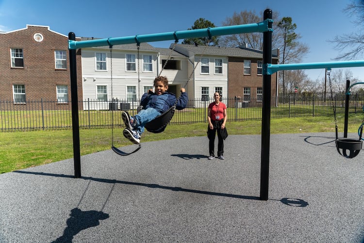 Rita and her son at the swingset