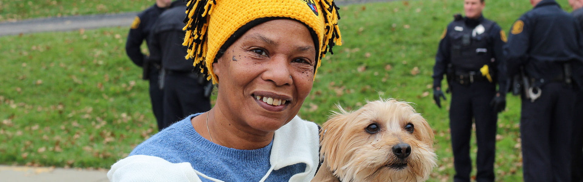 A woman smiling with a dog
