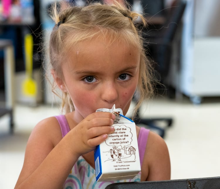 A child drinking milk indoors