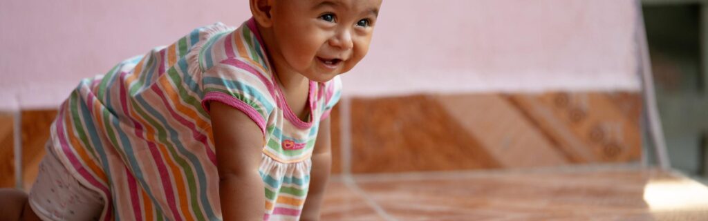 A toddler crawling on the floor indoors