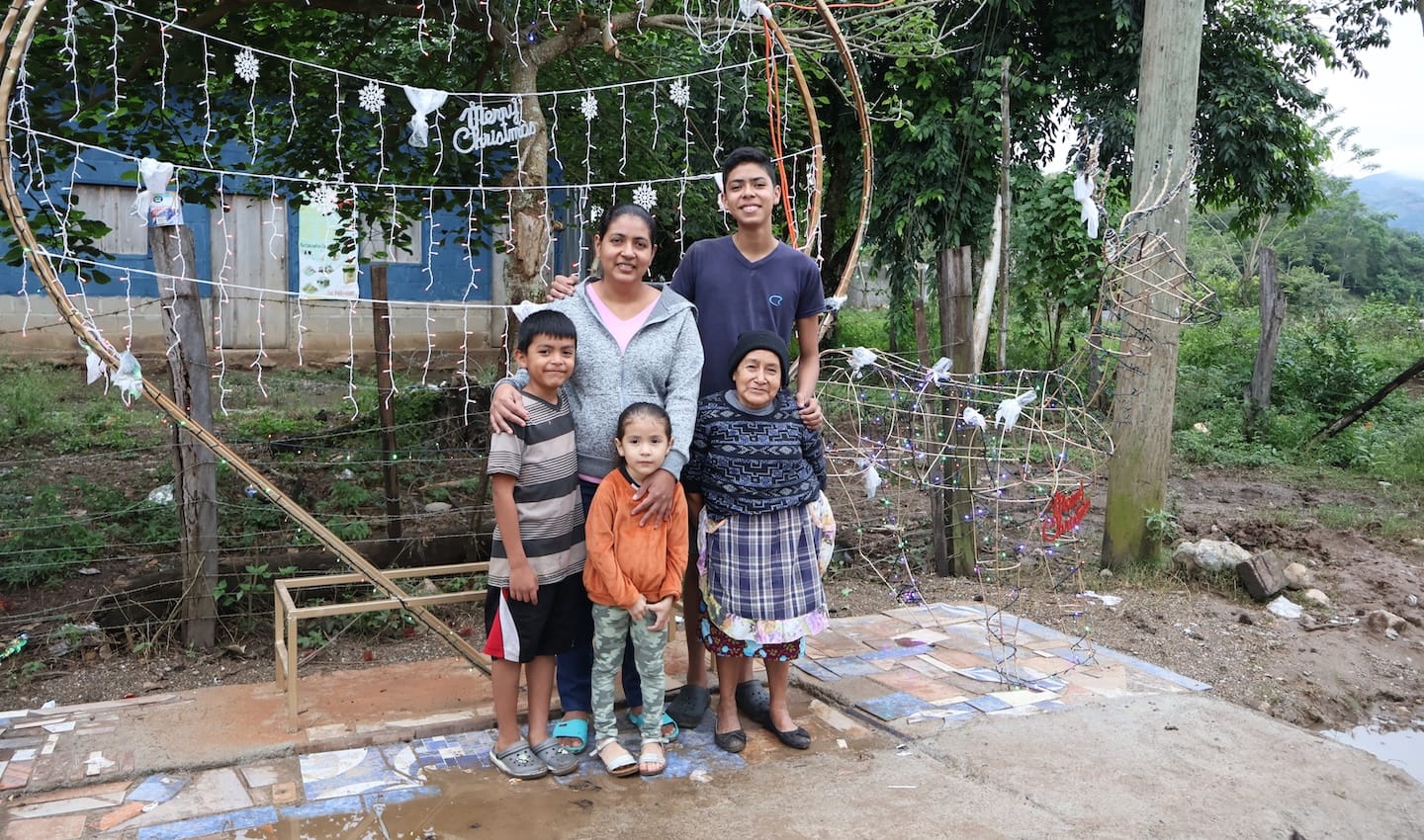 A family standing in front of a light feature outdoors.