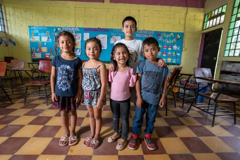 A group of children in a central american school classroom.