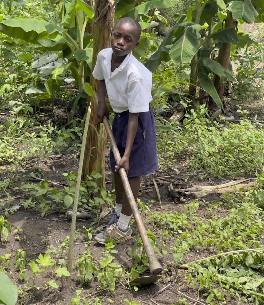 A child tending a garden in Tanzania.