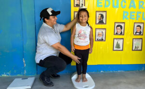 Yensy and a teacher in front of lockers