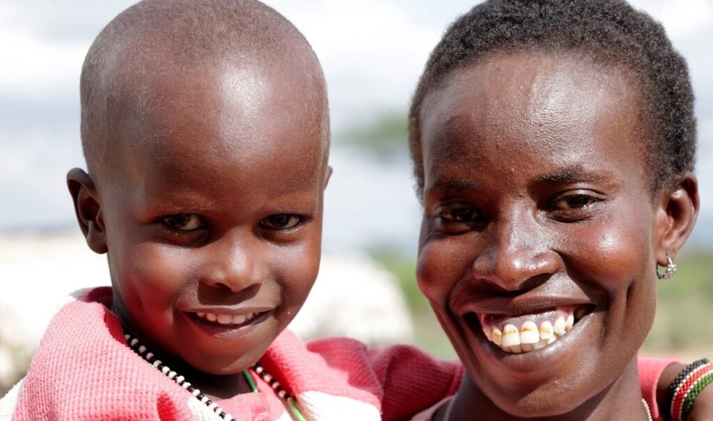 Alesia and Haron smiling outdoors in Kenya.