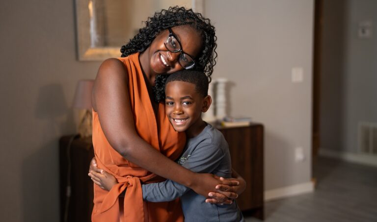 Julissa and Josiah hugging each other in a home.