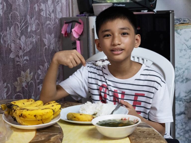 Andrew sitting at a table with bowls of food.